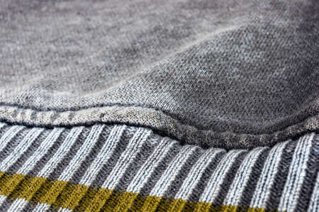 clothing items washed cotton fabric texture with seams, clasps, buttons and rivets, macro, close-up
