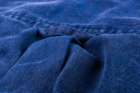 clothing items washed cotton fabric texture with seams, clasps, buttons and rivets, macro, close-upの写真素材