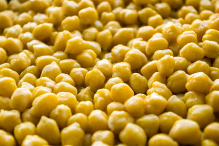 Cooking chickpeas with spices in a pan, close upの写真素材