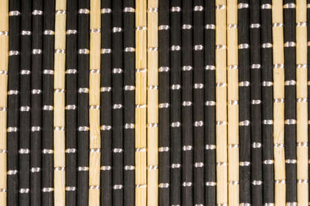 brown bamboo Mat - stand food, close-up, macro, black backgroundの写真素材