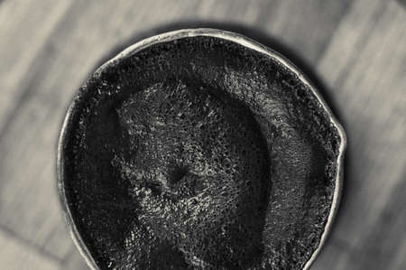 Natural coffee with thick foam, brewed in a copper cezve in the classical way, on a wooden...