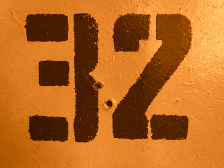 texture of old painted shabby wooden surface with numbers, close-up, grunge backgroundの写真素材