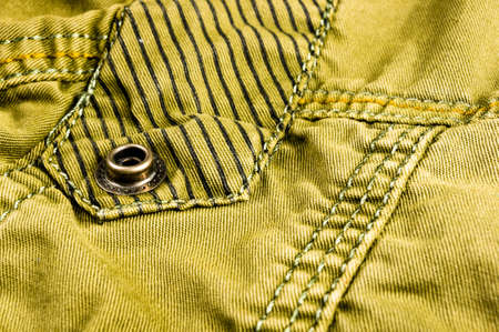 clothing items washed cotton fabric texture with seams, clasps, buttons and rivets, macro, close-upの写真素材