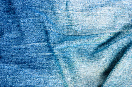 clothing items blue washed faded jeans cotton fabric texture with seams, clasps, buttons and rivets, macroの写真素材