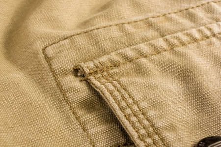 clothing items washed cotton fabric texture with seams, clasps, buttons and rivets, macro, close-upの写真素材