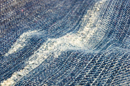 clothing items blue washed faded jeans cotton fabric texture with seams, clasps, buttons and rivets,...