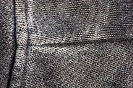 clothing items washed cotton fabric texture with seams, clasps, buttons and rivets, macro, close-up