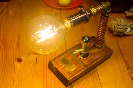 Light fixture handmade in vintage style, wooden case and radio tube, copper finish, led lampの写真素材