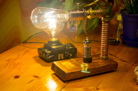 Light fixtures handmade in vintage style, retro film SLR camera case and wooden case, led lampsの写真素材