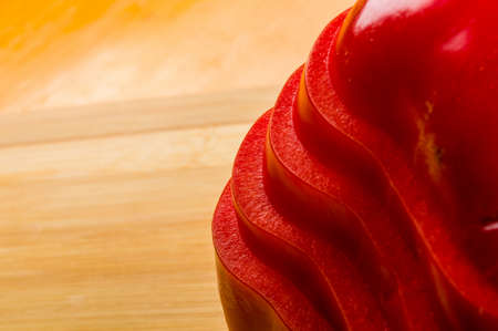 stacked pile of sliced fresh red paprika, bell pepper on bamboo cutting Board, close upの写真素材