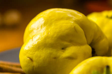 still life - large yellow quince fruits on a ceramic plate, with anise, cinnamon, and walnutsの写真素材