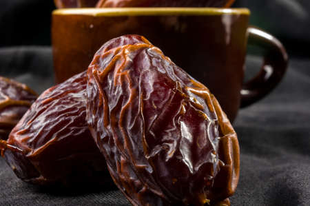 Big luxury dried date fruit on the dark surface, kurma ramadan kareem concept.の写真素材