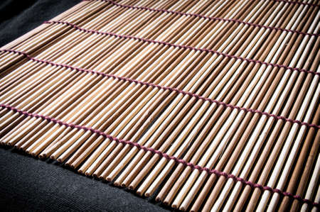 brown bamboo Mat - stand food, close-up, macro, black backgroundの写真素材