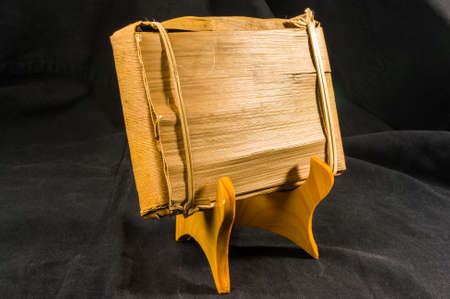 Chinese pressed PU-erh tea in bamboo leaf packaging on a special stand, close-upの写真素材