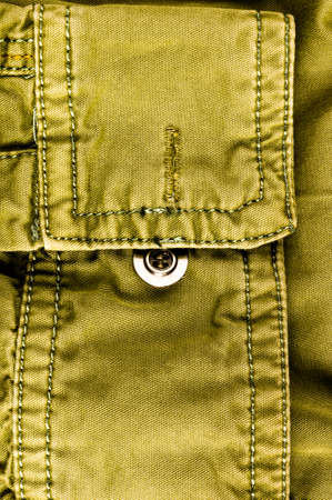 clothing items washed cotton fabric texture with seams, clasps, buttons and rivets, macro, close-up