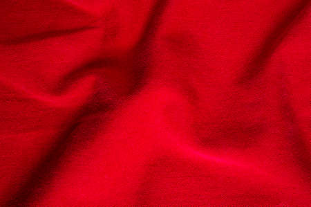 clothing items washed red cotton fabric texture with seams, clasps, buttons and rivets, macro,...
