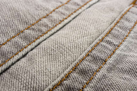 clothing items washed cotton fabric texture with seams, clasps, buttons and rivets, macro, close-upの写真素材