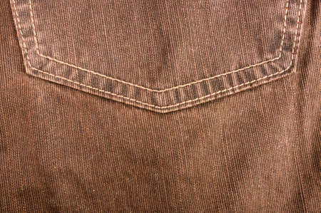clothing items washed cotton fabric texture with seams, clasps, buttons and rivets, macro, close-up