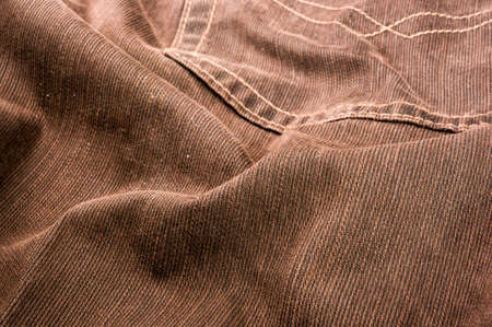 clothing items washed cotton fabric texture with seams, clasps, buttons and rivets, macro, close-upの写真素材