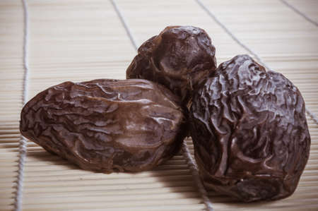 Big luxury dried date fruit on the bamboo mat, kurma ramadan kareem concept.の写真素材