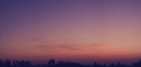 Landscape with dramatic light - beautiful golden sunset with saturated sky and clouds, peaceful nature serene background.の写真素材