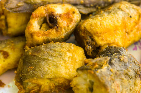 Pieces of navaga fish in batter, fried in oil in a pan, close-up.の写真素材