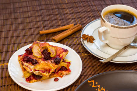Still life - a cup of black coffee, homemade cookies with fruit on a bamboo matの写真素材