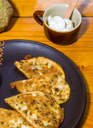 Vegetarian food - celery tuber slices fried in batter in a ceramic plate on a wooden tableの写真素材
