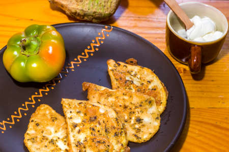 Vegetarian food - celery tuber slices fried in batter in a ceramic plate on a wooden tableの写真素材