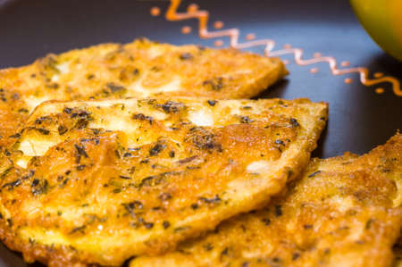 Vegetarian food - celery tuber slices fried in batter in a ceramic plate on a wooden tableの写真素材