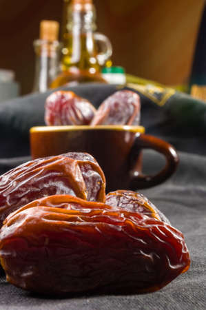 Big luxury dried date fruit on the dark surface, kurma ramadan kareem concept.の写真素材