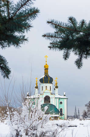 Winter landscape - Orthodox church in the snow among fir-trees on a frosty dayの写真素材
