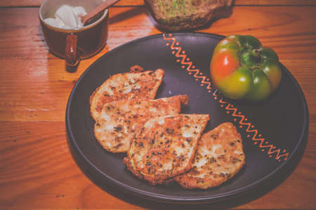 Vegetarian food - celery tuber slices fried in batter in a ceramic plate on a wooden tableの写真素材
