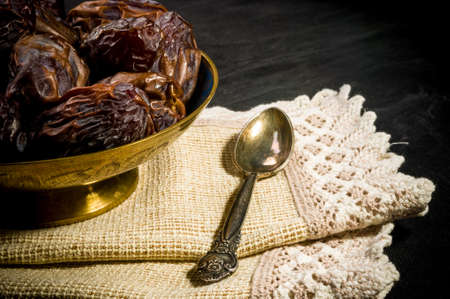 Big luxury dried date fruit in bowls on a linen napkin, kurma ramadan kareem concept.の写真素材