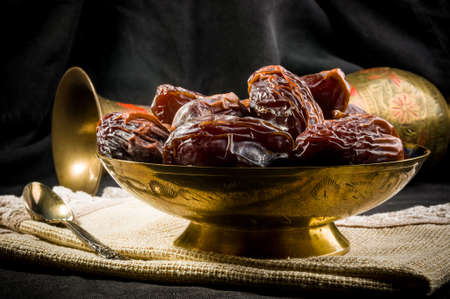 Big luxury dried date fruit in bowls on a linen napkin, kurma ramadan kareem concept.の写真素材