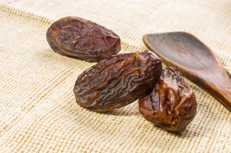 Big luxury dried date fruit on a linen napkin, kurma ramadan kareem concept.の写真素材