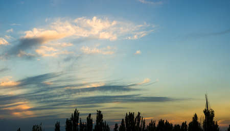 Landscape with dramatic light - beautiful golden sunset with saturated sky and clouds, peaceful nature serene background.の写真素材