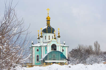 Winter landscape - Orthodox church in the snow among trees on a frosty dayの写真素材