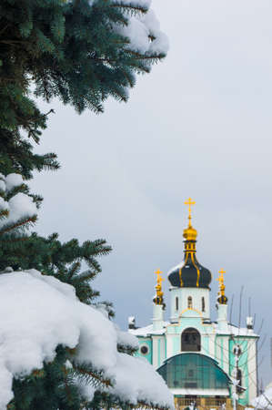 Winter landscape - Orthodox church in the snow among fir-trees on a frosty dayの写真素材