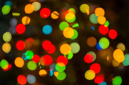 Christmas background-garlands with colorful lights on a decorated Christmas tree, bokeh, close-upの写真素材