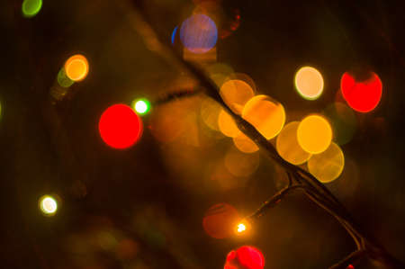 Christmas background-garlands with colorful lights on a decorated Christmas tree, bokeh, close-upの写真素材