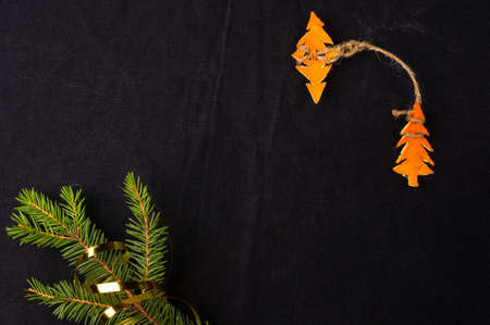 New Year Concept. Christmas decorations from tangerine peel and fir-tree branches on black backgroundの写真素材
