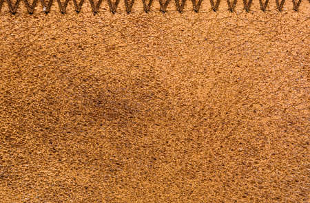 Old vintage genuine soft brown leather texture background, top layer with pores and scratches, macroの写真素材
