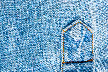 clothing items blue washed faded jeans cotton fabric texture with seams, clasps, buttons and rivets, macroの写真素材