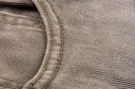 clothing items washed cotton fabric texture with seams, clasps, buttons and rivets, macro, close-upの写真素材