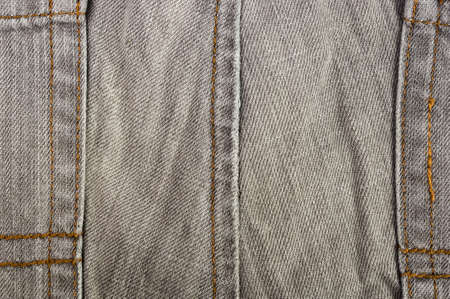 clothing items washed cotton fabric texture with seams, clasps, buttons and rivets, macro, close-upの写真素材