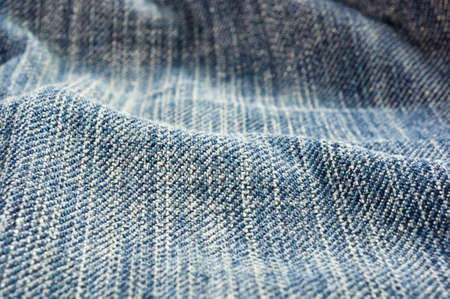 clothing items blue washed faded jeans cotton fabric texture with seams, clasps, buttons and rivets, macroの写真素材