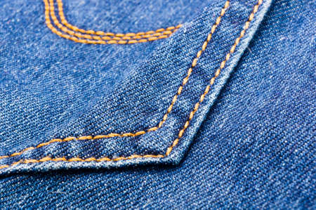 clothing items blue washed faded jeans cotton fabric texture with seams, clasps, buttons and rivets,...