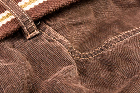 clothing items washed cotton fabric texture with seams, clasps, buttons and rivets, macro, close-up