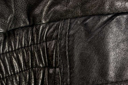 Old vintage genuine soft black leather texture background, top layer with pores and scratches, macroの写真素材